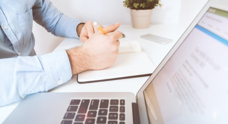 A manager efficiently planning a marketing campaign on their laptop with a user-friendly CRM for cafe.