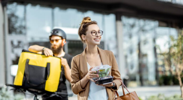 A delivery person completing an order, with customer details and preferences managed by a crm system for cafe.