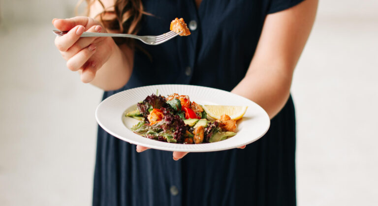 A close-up of a healthy salad held by a professional, a concept related to efficient warehouse accounting.
