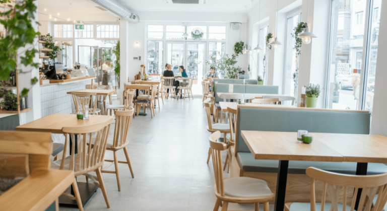 A bustling cafe interior where daily transactions are efficiently handled by software for cafe accounting